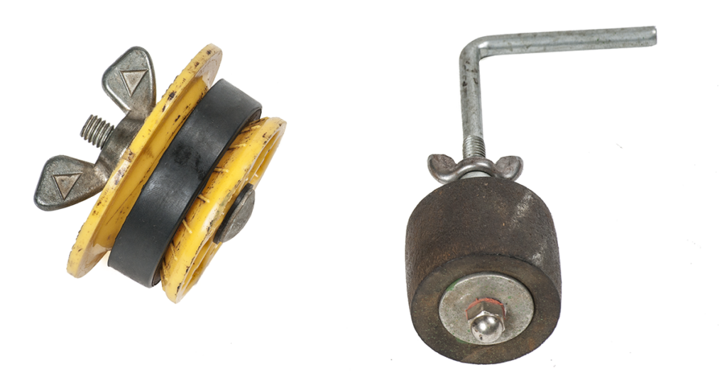 "Image of two hand-tightened expansion-type test plugs, featuring adjustable wing nuts and rubber sealing components."