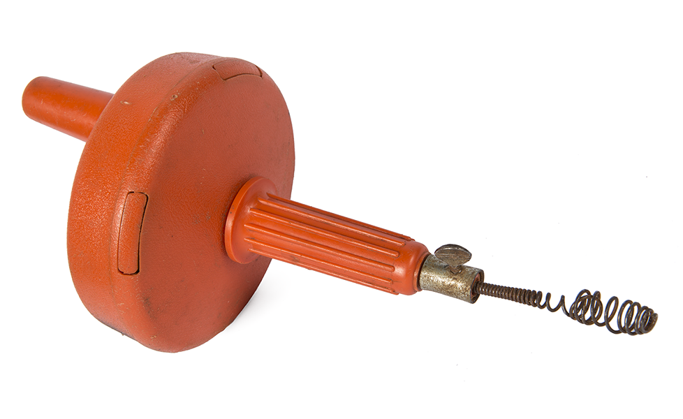 "Image of a hand-operated drain auger with an orange handle and casing, featuring a coiled tip for manual drain clearing."