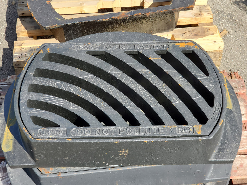 "Photo of a catch basin grate featuring environmental information and a fish icon, with the message 'Leads to fish habitat' and 'Do not pollute' engraved on it."